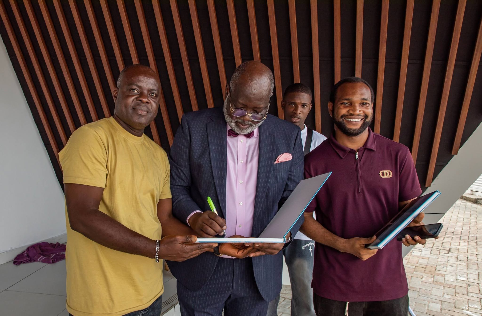 Dayo Adedayo the founder of the DAP Experience Centre signing the autograph