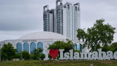 Two people waiting for transportation at a road in Islamabad, Pakistan. (Image : CNN World)
