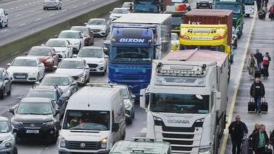 People making their way, on foot with luggage to bypass the traffic on Dublin's M50 north-bound towards the airport on Thursday