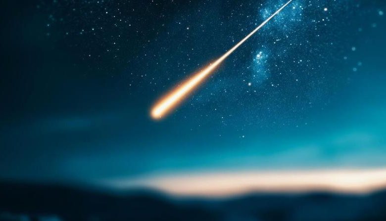 Dark sky with bright meteor falling