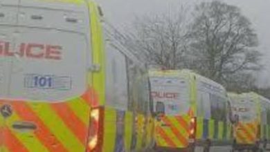 Police vehicles outside a school in Scotland with cordoned-off streets and emergency response activity.