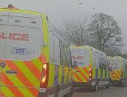Police vehicles outside a school in Scotland with cordoned-off streets and emergency response activity.