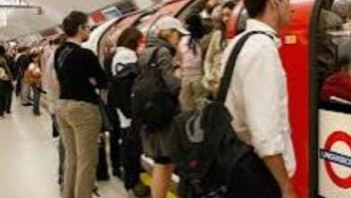 crowded London Underground platform during rush hour,