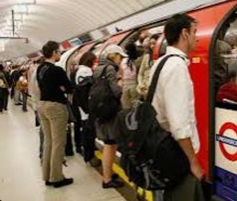 crowded London Underground platform during rush hour,