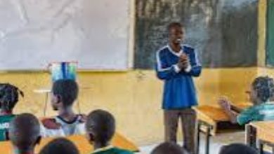 Image of Nigerian students in a classroom using textbooks