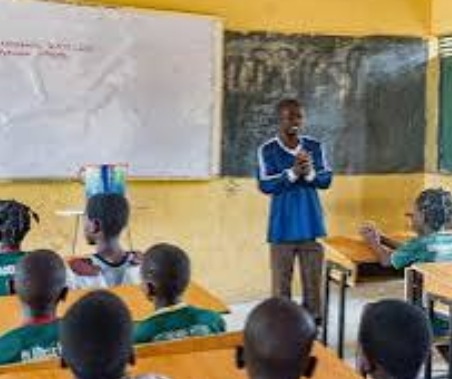 Image of Nigerian students in a classroom using textbooks