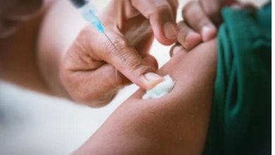 A healthcare worker administering an injection in a clinical setting