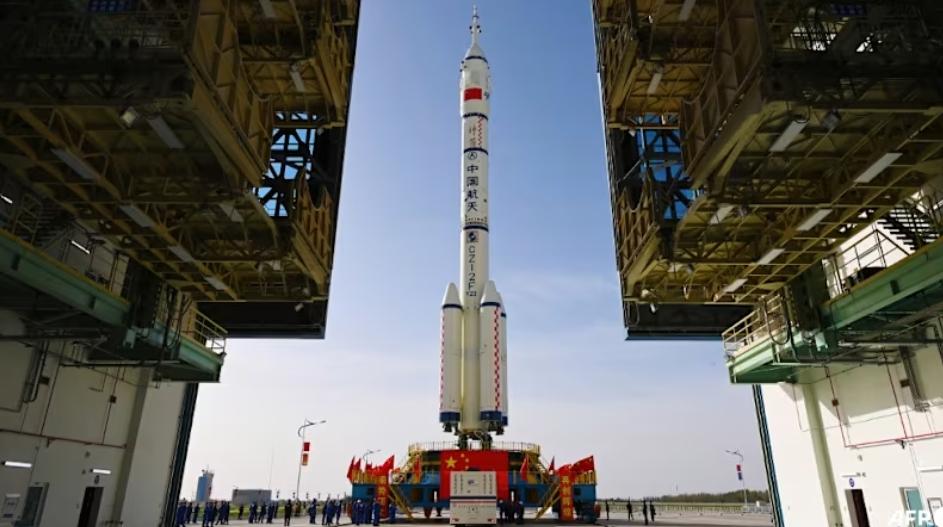 The Shenzhou-23 manned spacecraft and Long March-2F Y23 launch vehicle assembly is transported to the launch area at the Jiuquan Satellite Launch Centre in the Gobi desert, in northwest China 2026. (Photo: AFP/STR/CNS)