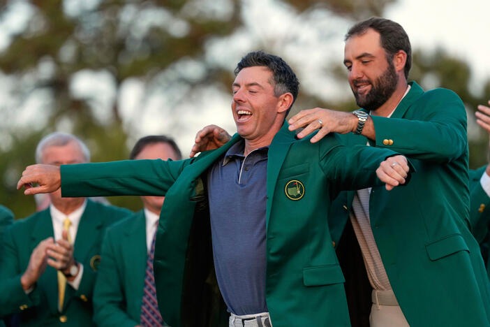 Scottie Scheffler puts the green Jacket on winner, Rory McIlroy, of Northern Ireland, at the Masters golf tournament, April 13, 2025, in Augusta, Ga. (AP Photo/Ashley Landis, File)4